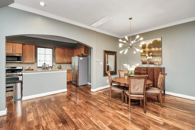 interior space with dark wood-type flooring, crown molding, and a chandelier