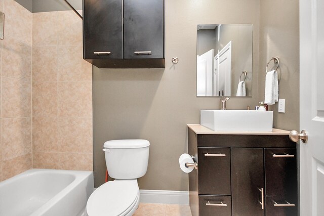 full bathroom featuring tiled shower / bath, vanity, toilet, and tile patterned floors