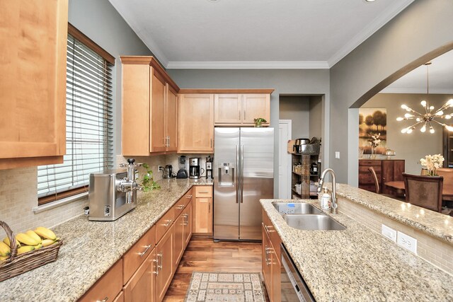 kitchen featuring decorative light fixtures, sink, stainless steel fridge with ice dispenser, light stone countertops, and light hardwood / wood-style flooring