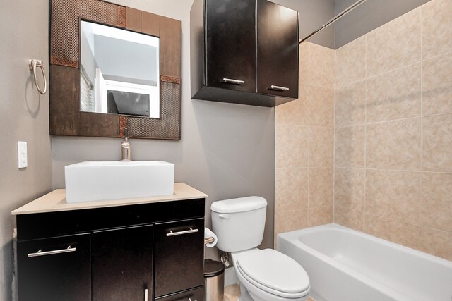 full bathroom featuring vanity, toilet, and tiled shower / bath combo