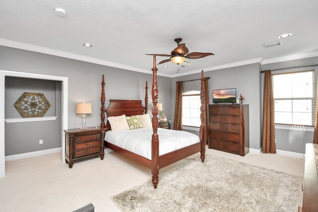 carpeted bedroom featuring crown molding, a textured ceiling, and ceiling fan