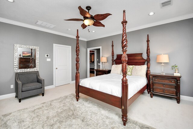 carpeted bedroom featuring ornamental molding, a walk in closet, ceiling fan, and a closet