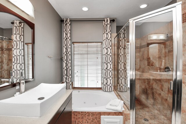 bathroom featuring sink and shower with separate bathtub