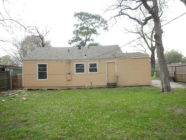 rear view of house featuring a yard