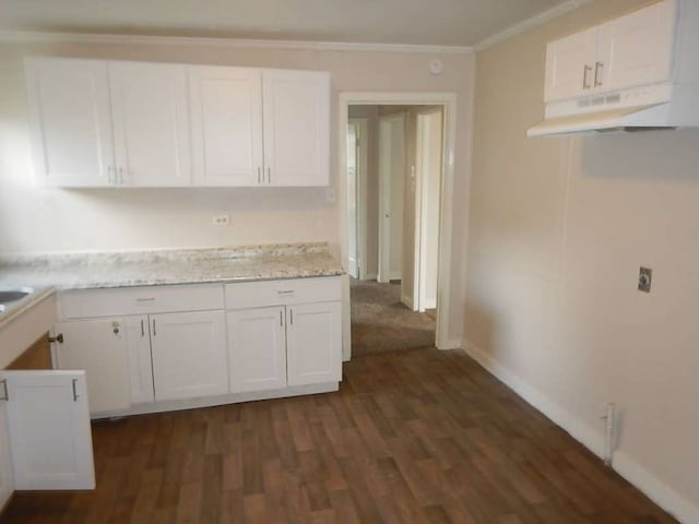 kitchen featuring light stone countertops, crown molding, white cabinets, and dark hardwood / wood-style floors