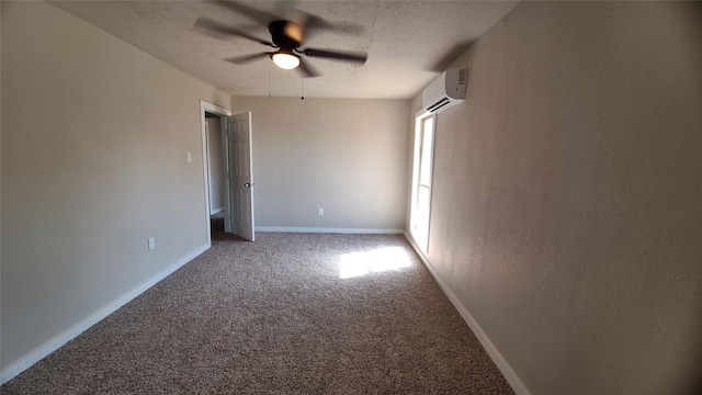 unfurnished bedroom featuring ceiling fan, carpet floors, a textured ceiling, and an AC wall unit