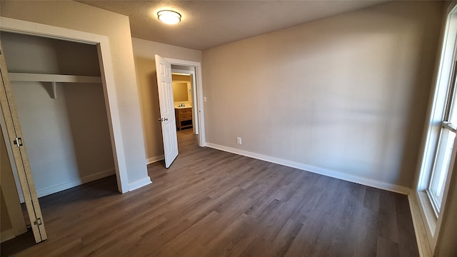 1284 Beaver Lake Dr, Caldwell, TX 77836 - unfurnished bedroom with dark wood finished floors, baseboards, and a closet
