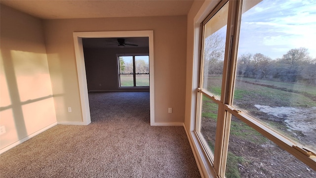 unfurnished sunroom featuring ceiling fan