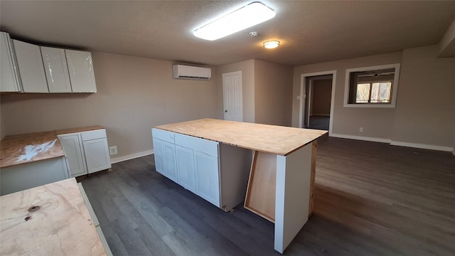 1284 Beaver Lake Dr, Caldwell, TX 77836 - kitchen featuring dark wood-style floors, an AC wall unit, and baseboards