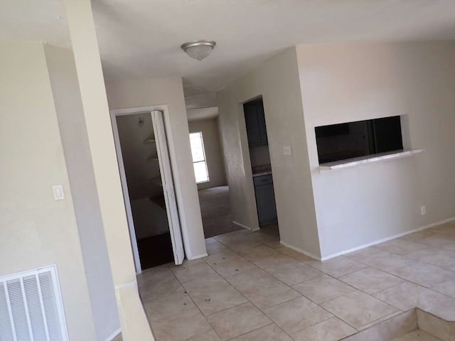 hall featuring light tile patterned flooring