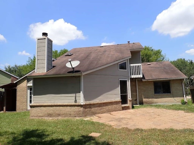 rear view of house featuring a yard and a patio