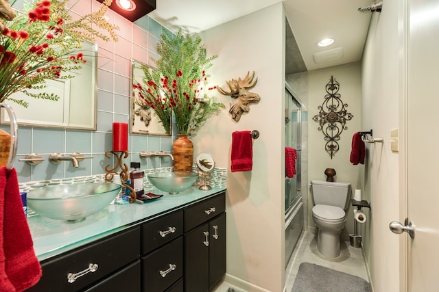 full bathroom with toilet, combined bath / shower with glass door, vanity, and tile patterned floors