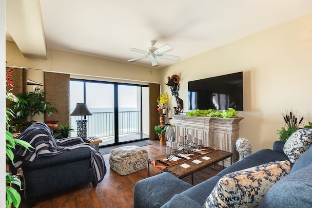 living room featuring ceiling fan and dark hardwood / wood-style flooring