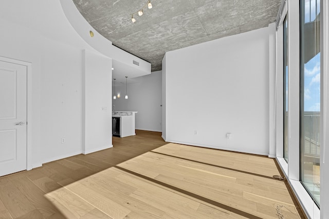 unfurnished living room featuring hardwood / wood-style floors and a wealth of natural light