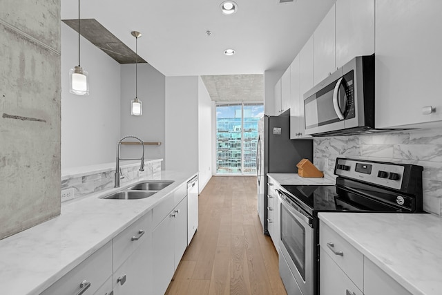 kitchen with white cabinetry, sink, and appliances with stainless steel finishes