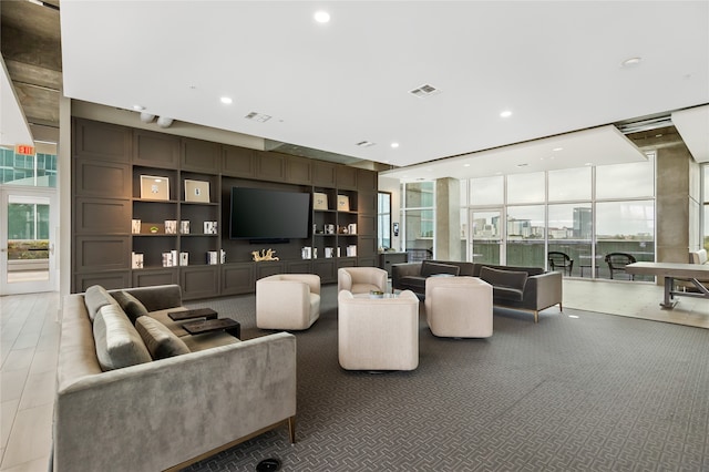 living room with expansive windows and built in features