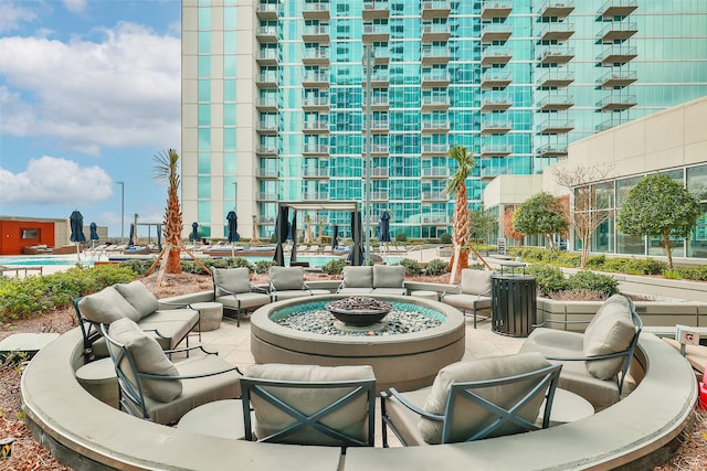 view of community featuring a patio area and an outdoor fire pit