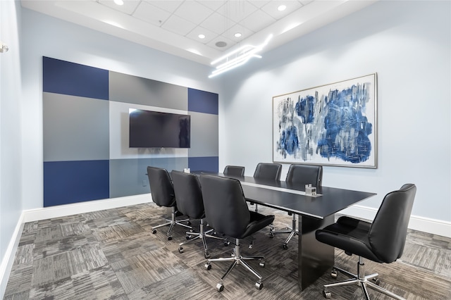 carpeted office with a raised ceiling