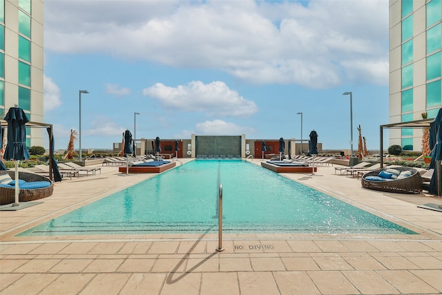 view of swimming pool featuring a patio area