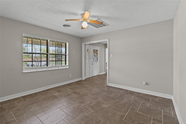 unfurnished room with a textured ceiling and ceiling fan