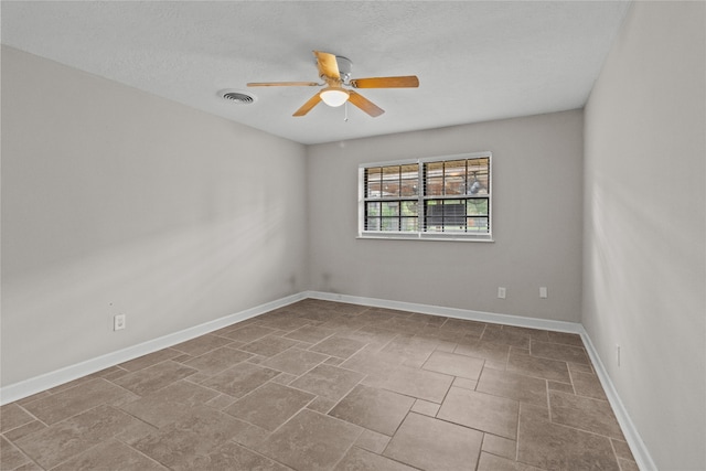 empty room featuring a textured ceiling and ceiling fan