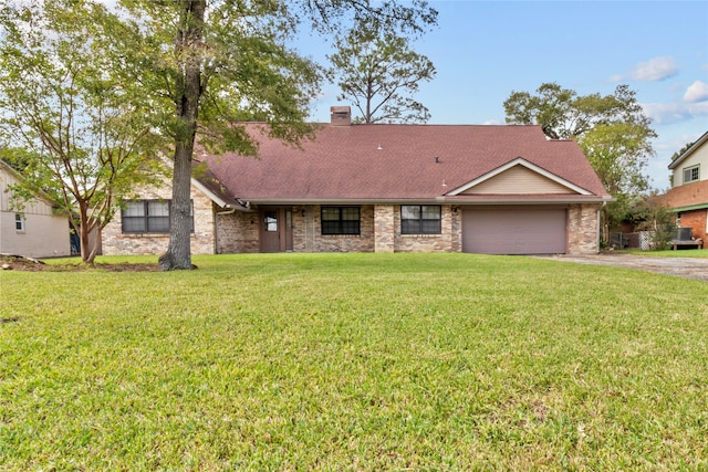 single story home featuring a garage and a front lawn