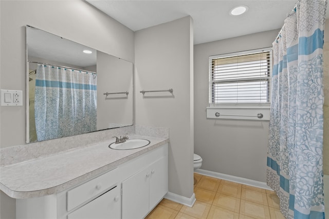 bathroom featuring walk in shower, vanity, and toilet