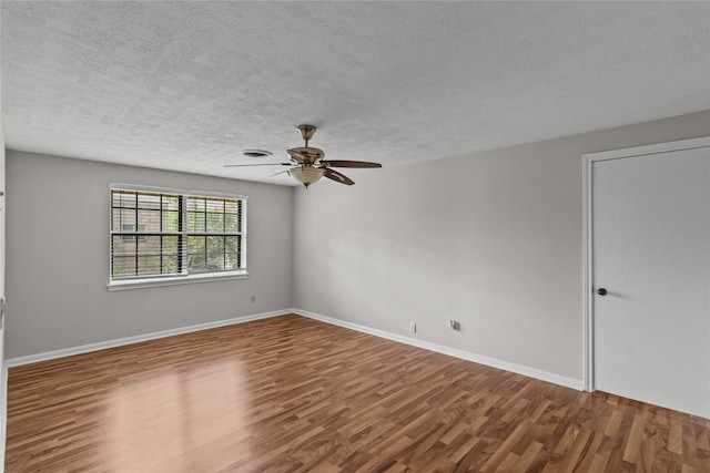 empty room featuring wood-type flooring, ceiling fan, and a textured ceiling