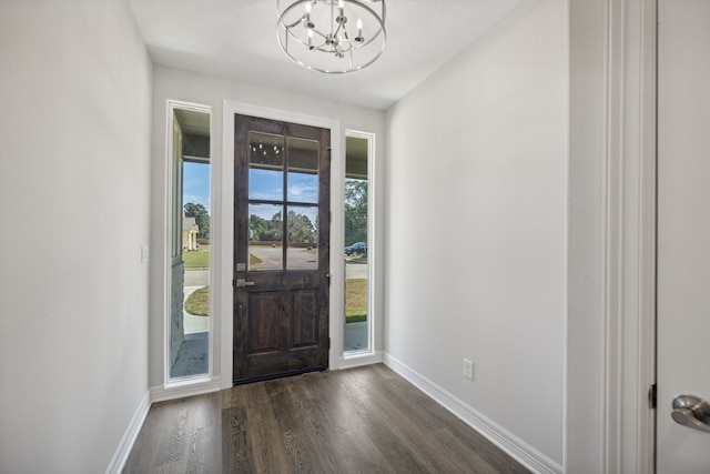 foyer featuring a chandelier and dark wood-type flooring