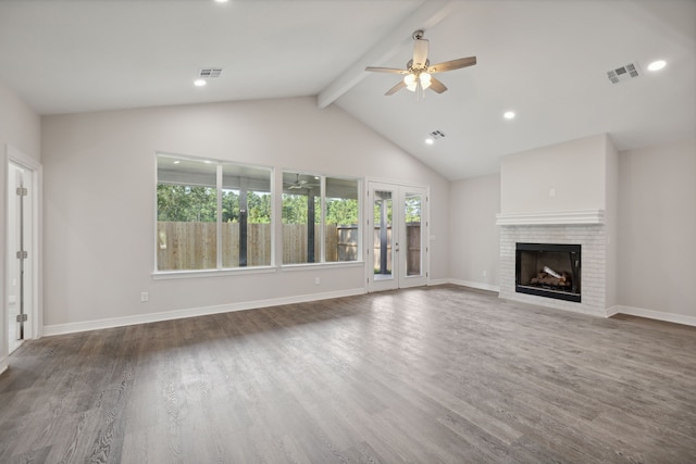 unfurnished living room featuring a ceiling fan, visible vents, a fireplace, wood finished floors, and vaulted ceiling with beams