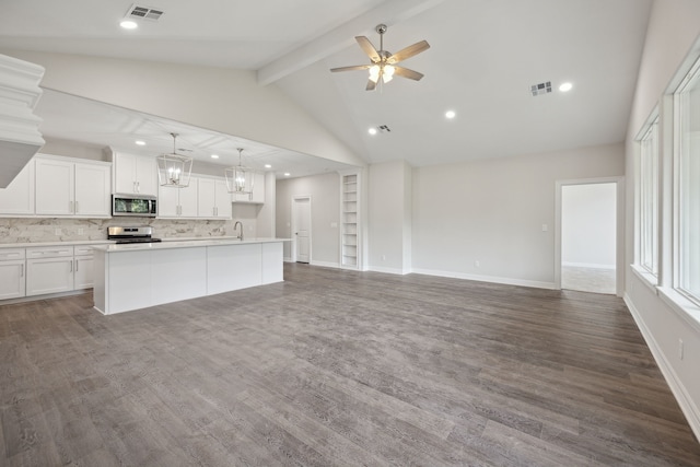 unfurnished living room featuring visible vents, a ceiling fan, dark wood finished floors, and lofted ceiling with beams