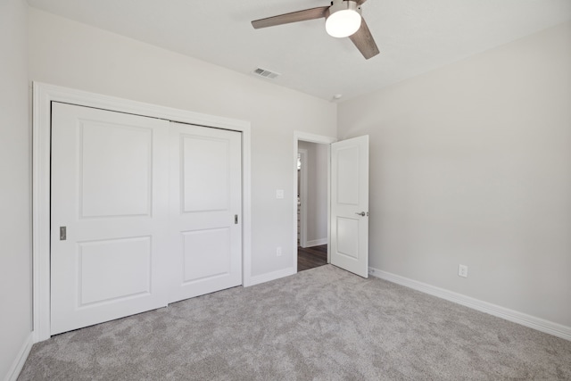 unfurnished bedroom featuring ceiling fan, carpet floors, baseboards, visible vents, and a closet