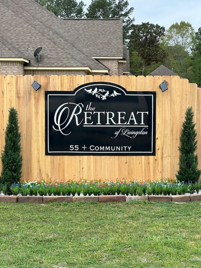 community sign featuring a lawn