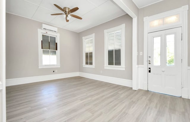 entrance foyer with ceiling fan, light hardwood / wood-style flooring, and a wall mounted air conditioner