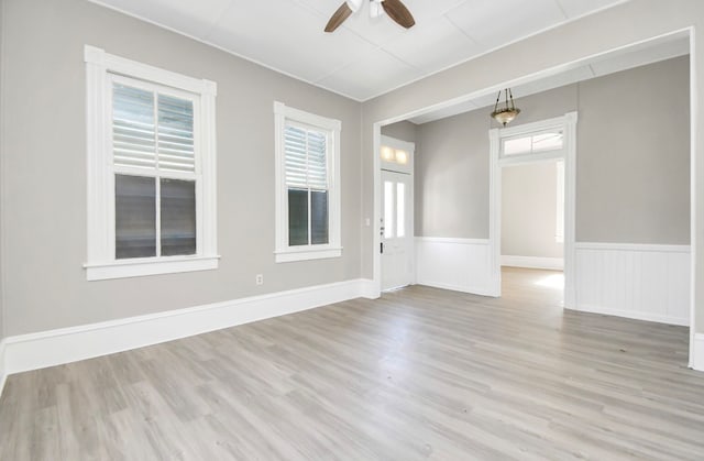 spare room featuring light hardwood / wood-style floors and ceiling fan