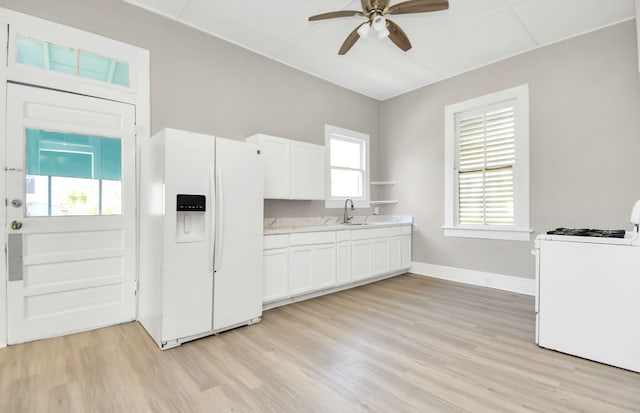 kitchen featuring light hardwood / wood-style floors, ceiling fan, white appliances, and white cabinets