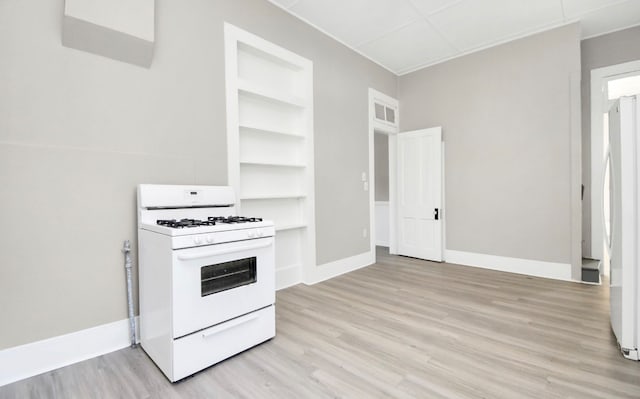 kitchen featuring light hardwood / wood-style floors, built in features, and white range with gas stovetop