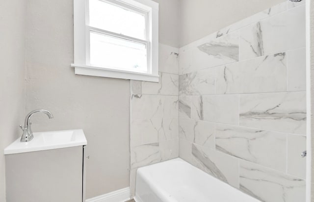 bathroom with vanity and tiled shower / bath combo