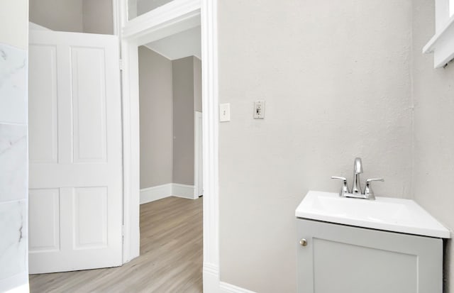 bathroom with vanity and hardwood / wood-style flooring