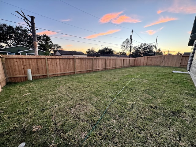 view of yard at dusk