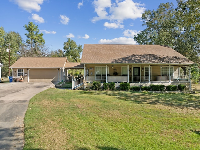 view of front of house featuring a porch, a front lawn, and a garage