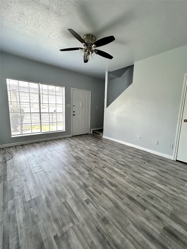 unfurnished living room with hardwood / wood-style floors, a textured ceiling, and ceiling fan