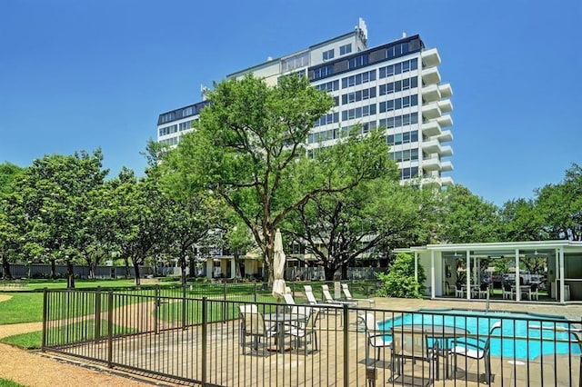 pool featuring a patio, fence, and a yard
