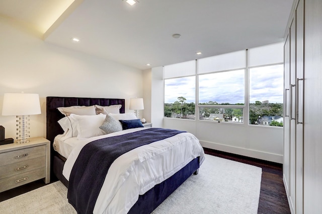 bedroom featuring dark wood-style floors, baseboards, and recessed lighting