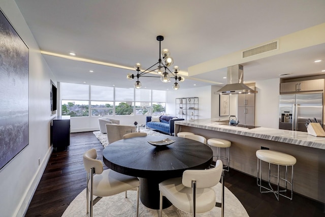 dining area featuring a notable chandelier, dark wood-style floors, recessed lighting, and visible vents