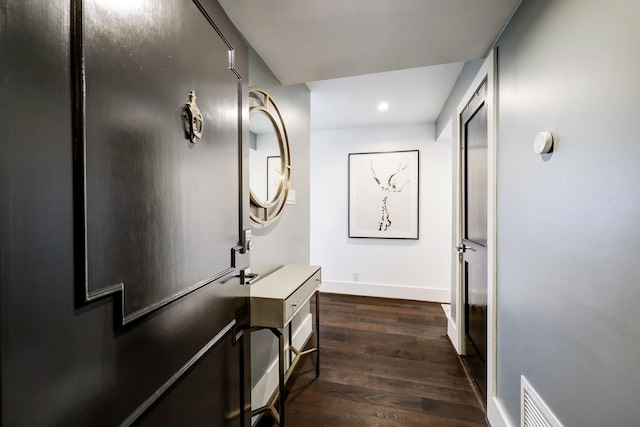 hallway with dark wood-style floors, recessed lighting, visible vents, and baseboards