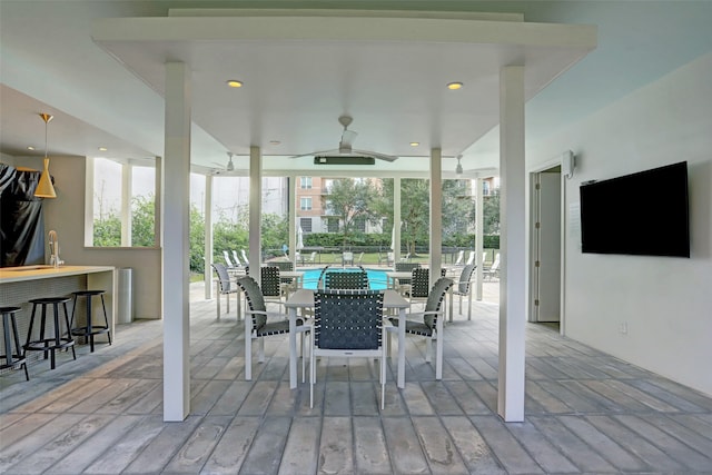 view of patio with a bar and ceiling fan