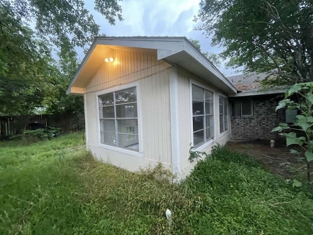 view of side of property featuring a yard