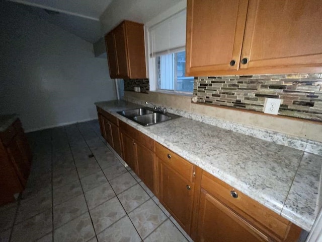 kitchen with sink, light tile patterned floors, and tasteful backsplash