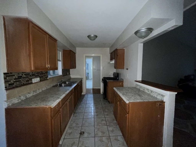 kitchen with sink, black range with gas cooktop, and light tile patterned floors